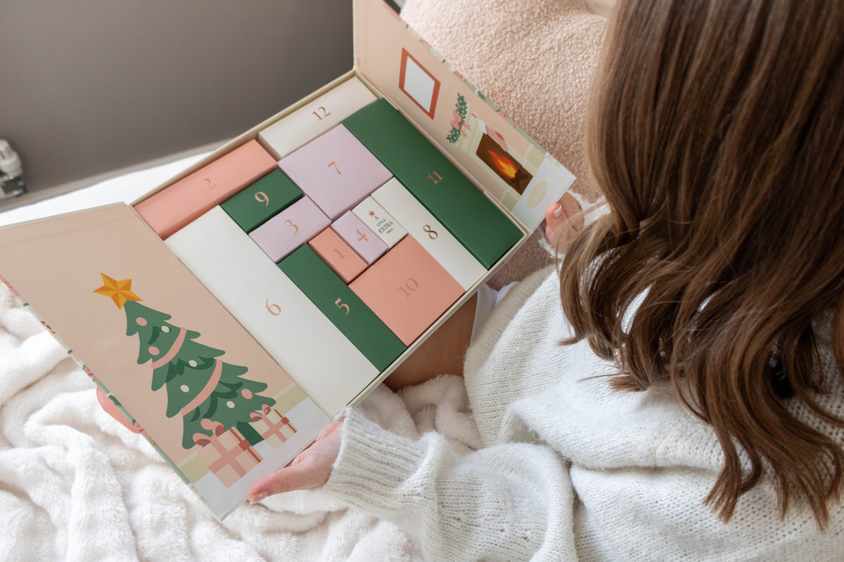 Woman opening the FFS Advent Calendar showing numbered doors